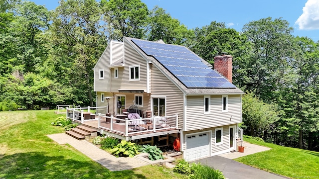 2 Pent Rd, Bloomfield, CT 06002 - view of front of property with a front lawn, roof mounted solar panels, driveway, and a chimney