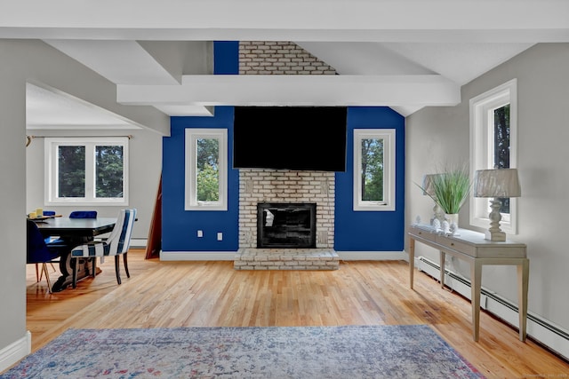 2 Pent Rd, Bloomfield, CT 06002 - living room with a baseboard heating unit, wood finished floors, lofted ceiling, and a fireplace