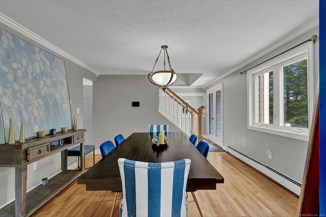 2 Pent Rd, Bloomfield, CT 06002 - dining room with a baseboard heating unit, stairs, light wood-style floors, ornamental molding, and a textured ceiling