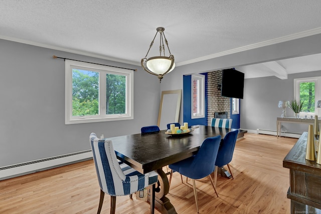 2 Pent Rd, Bloomfield, CT 06002 - dining area featuring light wood finished floors, a baseboard heating unit, ornamental molding, and a textured ceiling