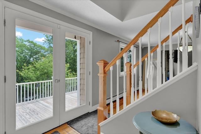2 Pent Rd, Bloomfield, CT 06002 - entryway featuring a baseboard radiator, wood finished floors, crown molding, stairway, and french doors