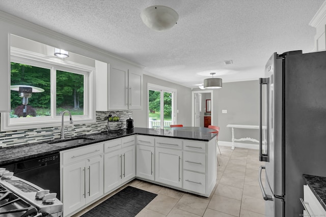 2 Pent Rd, Bloomfield, CT 06002 - kitchen with freestanding refrigerator, decorative backsplash, a peninsula, white cabinets, and dark stone countertops