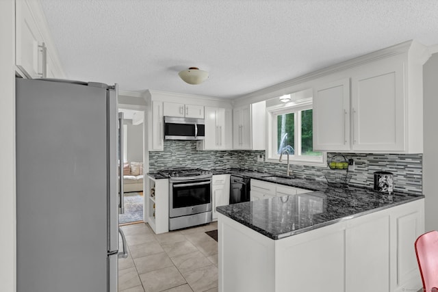 2 Pent Rd, Bloomfield, CT 06002 - kitchen featuring stainless steel appliances, a peninsula, white cabinetry, a textured ceiling, and decorative backsplash