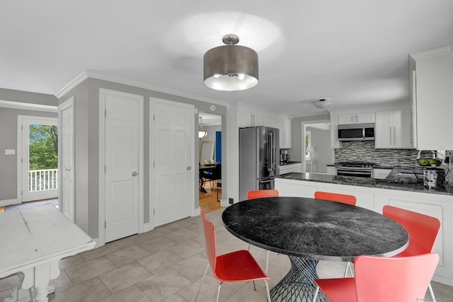 2 Pent Rd, Bloomfield, CT 06002 - kitchen featuring appliances with stainless steel finishes, tasteful backsplash, white cabinets, a peninsula, and crown molding