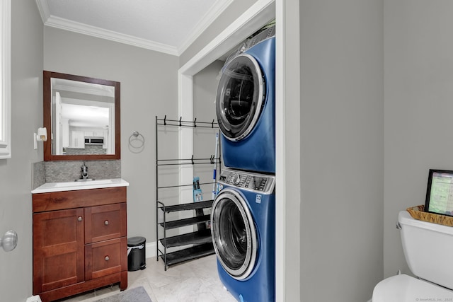 2 Pent Rd, Bloomfield, CT 06002 - bathroom with stacked washing machine and dryer, ornamental molding, vanity, and tasteful backsplash