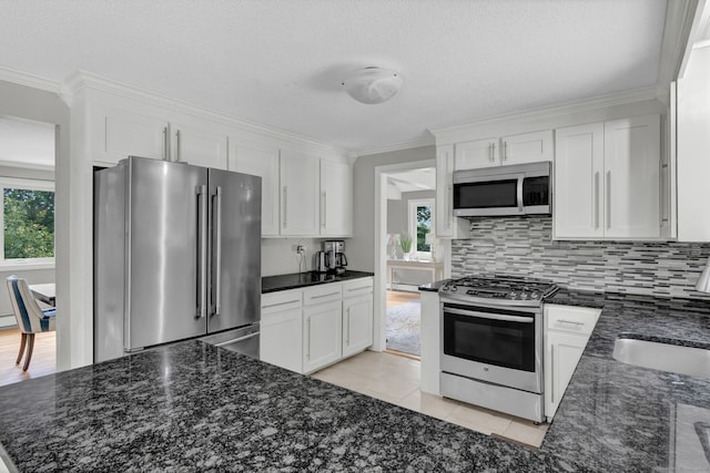 2 Pent Rd, Bloomfield, CT 06002 - kitchen featuring stainless steel appliances, white cabinetry, crown molding, backsplash, and a textured ceiling