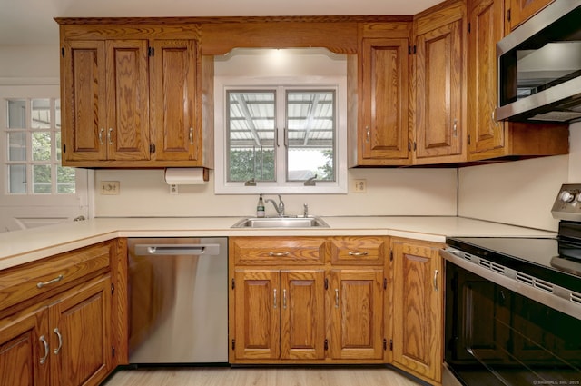 64 Regina St, Trumbull, CT 06611 - kitchen with stainless steel appliances, a sink, and brown cabinetry