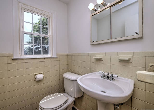 64 Regina St, Trumbull, CT 06611 - half bath with toilet, a wainscoted wall, tile walls, and a sink