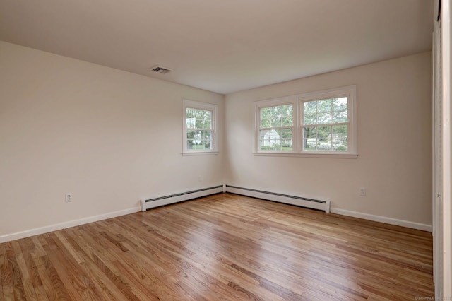 64 Regina St, Trumbull, CT 06611 - empty room with light wood finished floors, baseboards, and a baseboard radiator