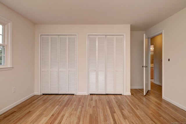 64 Regina St, Trumbull, CT 06611 - unfurnished bedroom with two closets, light wood-style flooring, and baseboards