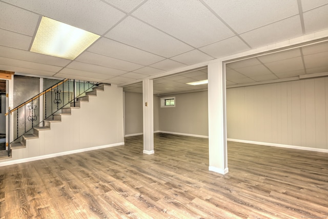 64 Regina St, Trumbull, CT 06611 - below grade area with wood finished floors, stairs, a paneled ceiling, and baseboards