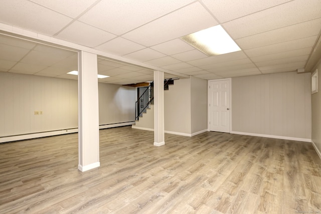 64 Regina St, Trumbull, CT 06611 - finished below grade area featuring a drop ceiling, wood finished floors, stairs, baseboards, and a baseboard heating unit