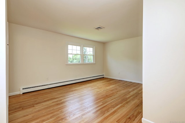 64 Regina St, Trumbull, CT 06611 - spare room with a baseboard heating unit, wood finished floors, and baseboards