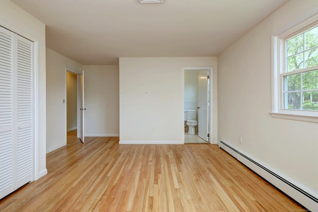 64 Regina St, Trumbull, CT 06611 - unfurnished bedroom with baseboard heating, light wood-type flooring, baseboards, a closet, and ensuite bathroom