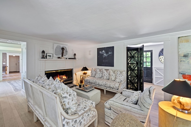 6 Over Rock Ln, Westport, CT 06880 - living area featuring a glass covered fireplace, light wood-type flooring, and crown molding
