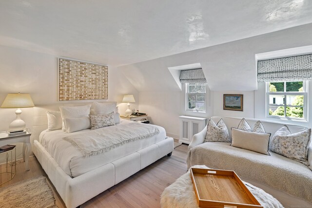 6 Over Rock Ln, Westport, CT 06880 - bedroom featuring multiple windows, wood finished floors, radiator, and vaulted ceiling