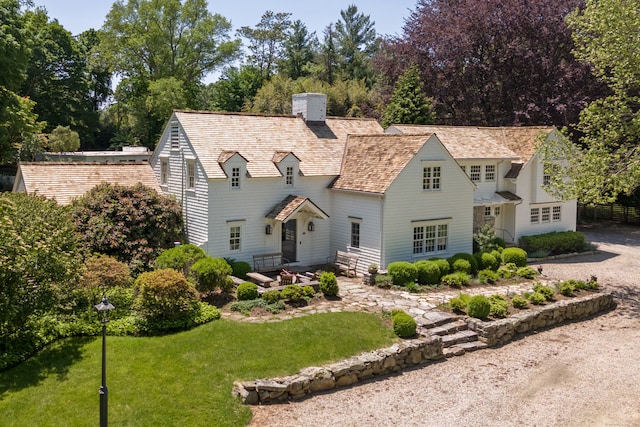 6 Over Rock Ln, Westport, CT 06880 - shingle-style home with a chimney, a front lawn, view of scattered trees, and roof with shingles