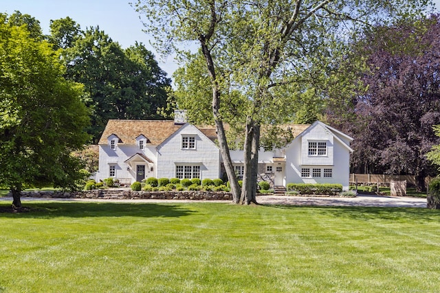 6 Over Rock Ln, Westport, CT 06880 - shingle-style home featuring a front lawn, a chimney, and view of scattered trees