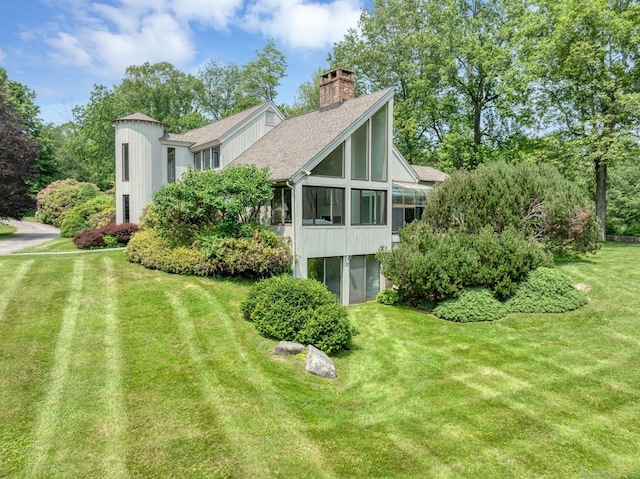76 Farview Farm Rd, Redding, CT 06896 - rear view of property with a sunroom, a chimney, a shingled roof, and a yard