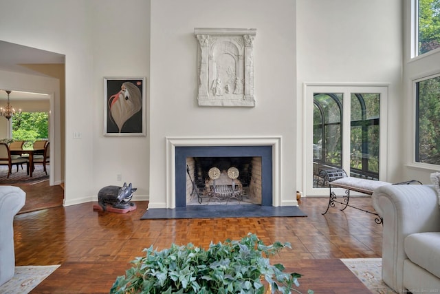 76 Farview Farm Rd, Redding, CT 06896 - living area with a fireplace with raised hearth, a chandelier, and a high ceiling
