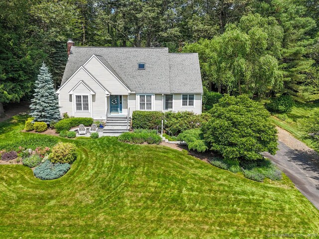 152 Hollyberry Rd, Bristol, CT 06010 - new england style home featuring a front yard, a chimney, and a shingled roof
