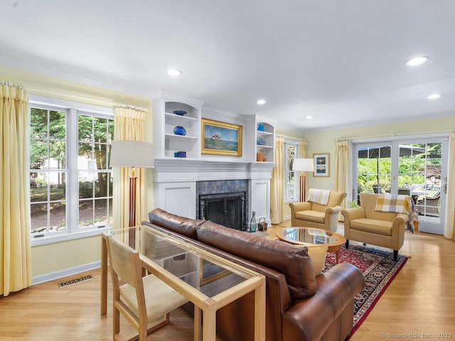 152 Hollyberry Rd, Bristol, CT 06010 - living room featuring plenty of natural light, recessed lighting, a fireplace, light wood-style flooring, and ornamental molding