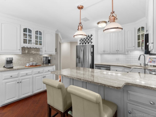 152 Hollyberry Rd, Bristol, CT 06010 - kitchen with appliances with stainless steel finishes, a kitchen bar, decorative backsplash, glass insert cabinets, and white cabinets