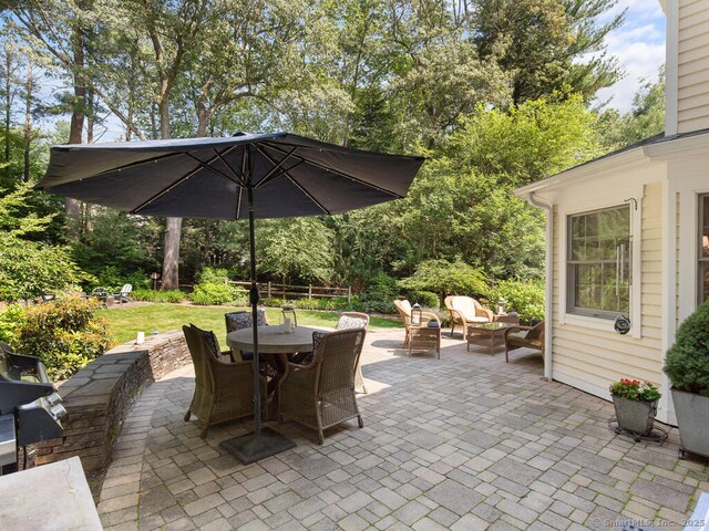 152 Hollyberry Rd, Bristol, CT 06010 - view of patio / terrace with outdoor dining space and view of wooded area
