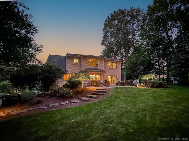 152 Hollyberry Rd, Bristol, CT 06010 - rear view of house with a chimney and a lawn