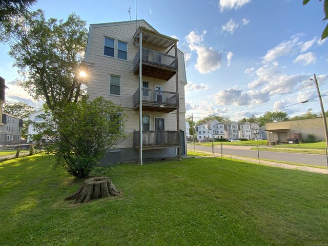 240 Martin St, Hartford, CT 06120 - rear view of house with a balcony, a lawn, and a residential view