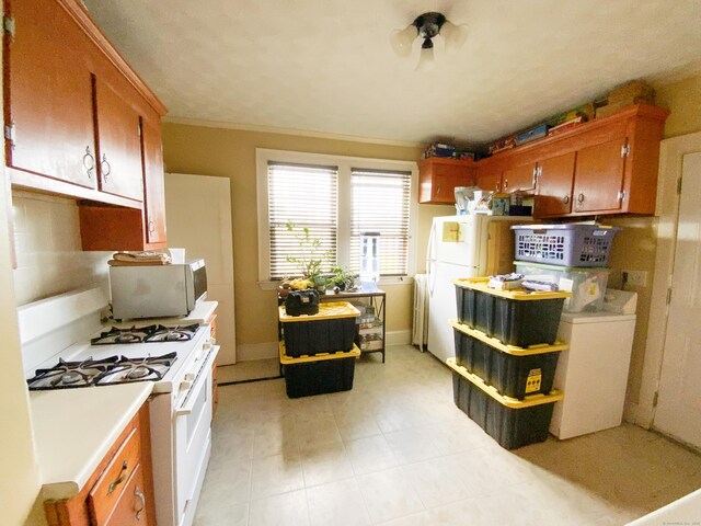 240 Martin St, Hartford, CT 06120 - kitchen featuring white appliances, light countertops, and brown cabinets