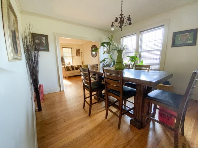 240 Martin St, Hartford, CT 06120 - dining room with healthy amount of natural light, light wood-style flooring, a chandelier, and baseboards