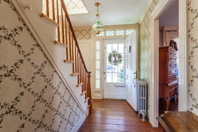 163 Lake Rd, Warren, CT 06754 - entryway with wood-type flooring, wallpapered walls, stairway, radiator heating unit, and ornamental molding