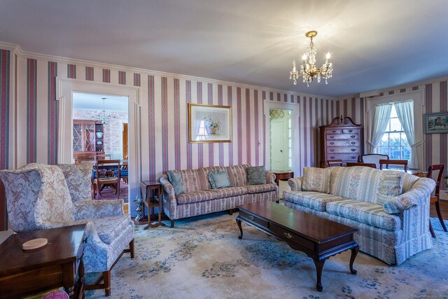 163 Lake Rd, Warren, CT 06754 - living room featuring a chandelier, wallpapered walls, and crown molding