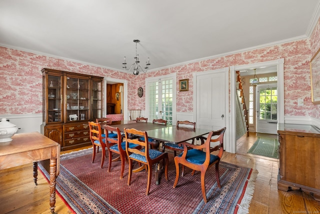 163 Lake Rd, Warren, CT 06754 - dining area with wallpapered walls, a wainscoted wall, a chandelier, light wood-type flooring, and ornamental molding