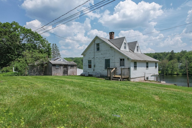 46 Bellamy Ln, Bethlehem, CT 06751 - rear view of property with a chimney, a lawn, an outbuilding, and a water view