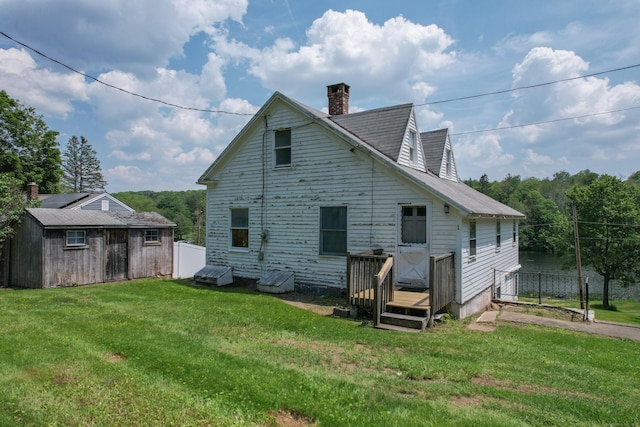 46 Bellamy Ln, Bethlehem, CT 06751 - rear view of property featuring a yard, a chimney, a wooden deck, and an outbuilding