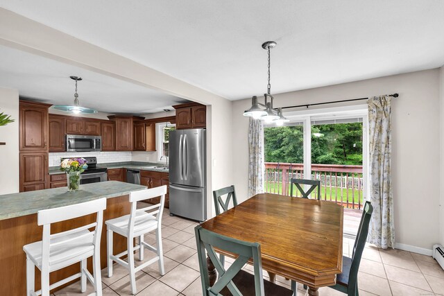 25 Meadow Dr, Ledyard, CT 06335 - dining space with light tile patterned floors, baseboard heating, and baseboards
