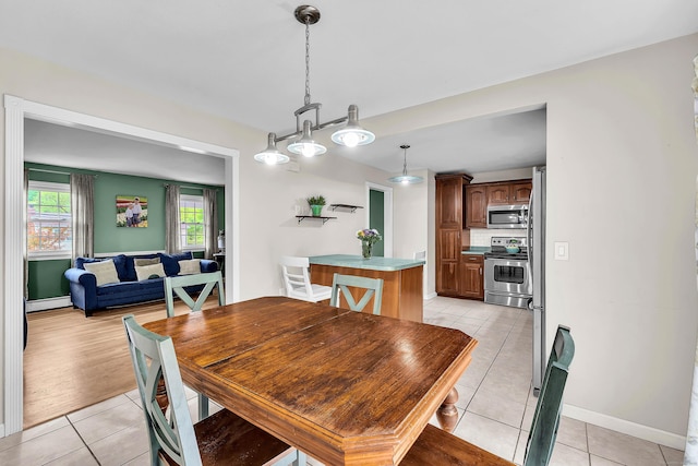 25 Meadow Dr, Ledyard, CT 06335 - dining space featuring light tile patterned floors, a baseboard heating unit, and baseboards