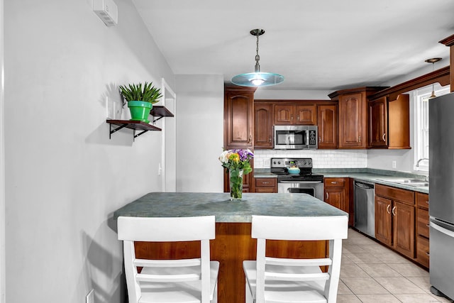 25 Meadow Dr, Ledyard, CT 06335 - kitchen with stainless steel appliances, a sink, decorative backsplash, a breakfast bar, and hanging light fixtures
