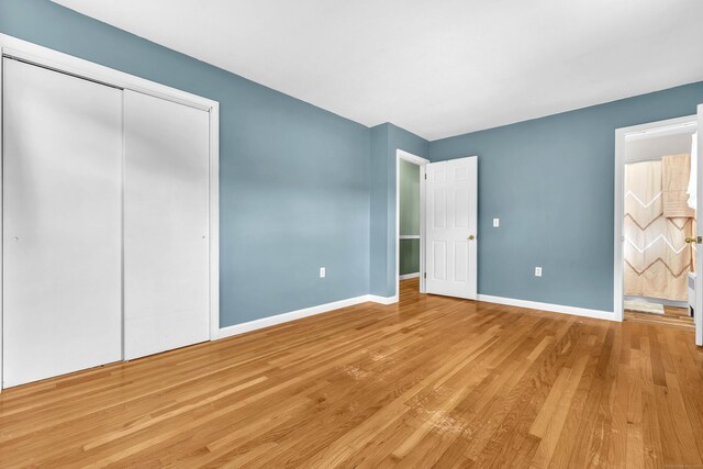 25 Meadow Dr, Ledyard, CT 06335 - unfurnished bedroom with light wood-type flooring, baseboards, a closet, and connected bathroom