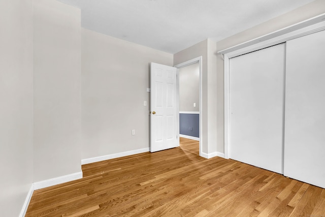 25 Meadow Dr, Ledyard, CT 06335 - unfurnished bedroom featuring light wood-style flooring, baseboards, and a closet