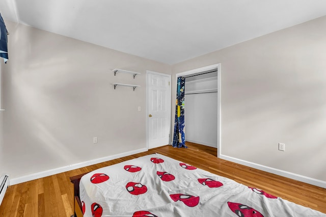 25 Meadow Dr, Ledyard, CT 06335 - bedroom featuring baseboards, wood finished floors, a baseboard heating unit, and a closet