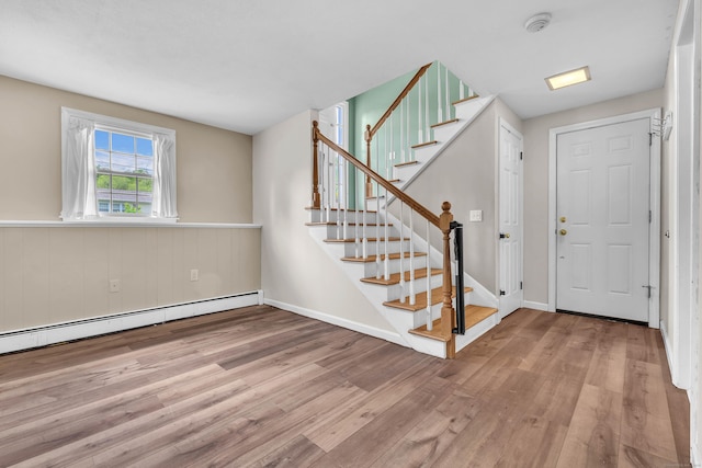 25 Meadow Dr, Ledyard, CT 06335 - foyer with wood finished floors, a baseboard heating unit, stairway, and baseboards