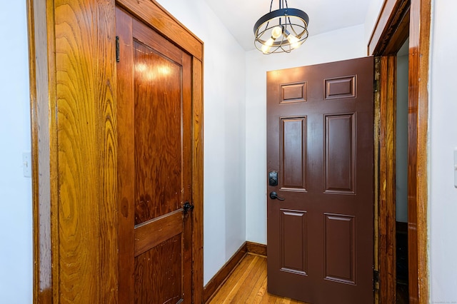 98 Gorham Ave, Hamden, CT 06514 - entryway with light wood-style floors, baseboards, and a chandelier