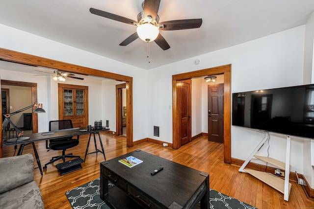 98 Gorham Ave, Hamden, CT 06514 - living room featuring a ceiling fan, an office area, baseboards, and light wood-type flooring