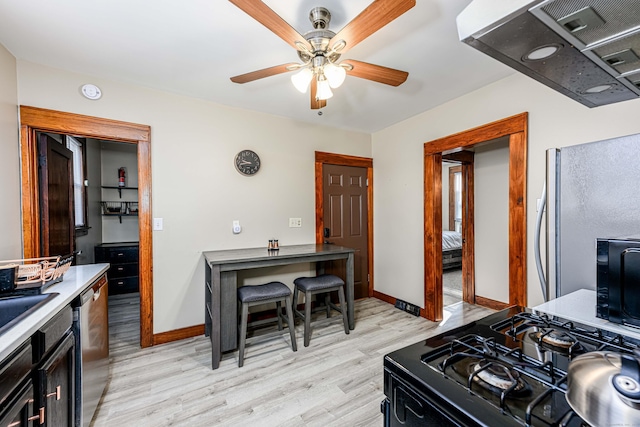 98 Gorham Ave, Hamden, CT 06514 - kitchen with ventilation hood, black appliances, light wood-style floors, a ceiling fan, and baseboards