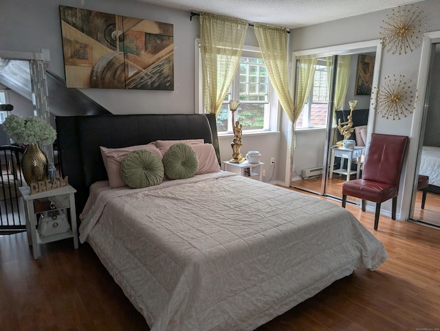 101 Chipper Rd, Waterbury, CT 06704 - bedroom with wood finished floors, baseboard heating, and a textured ceiling