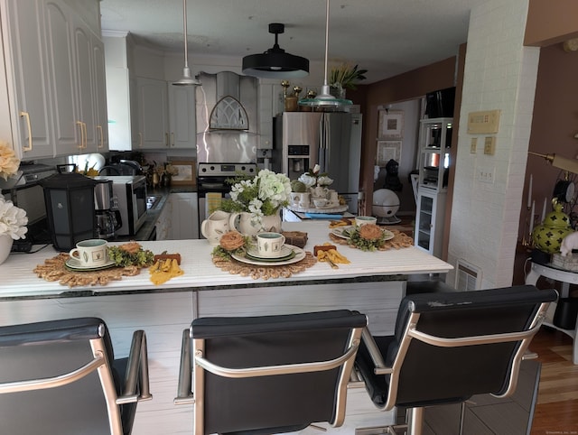 101 Chipper Rd, Waterbury, CT 06704 - kitchen featuring custom range hood, stainless steel appliances, a peninsula, a breakfast bar, and pendant lighting
