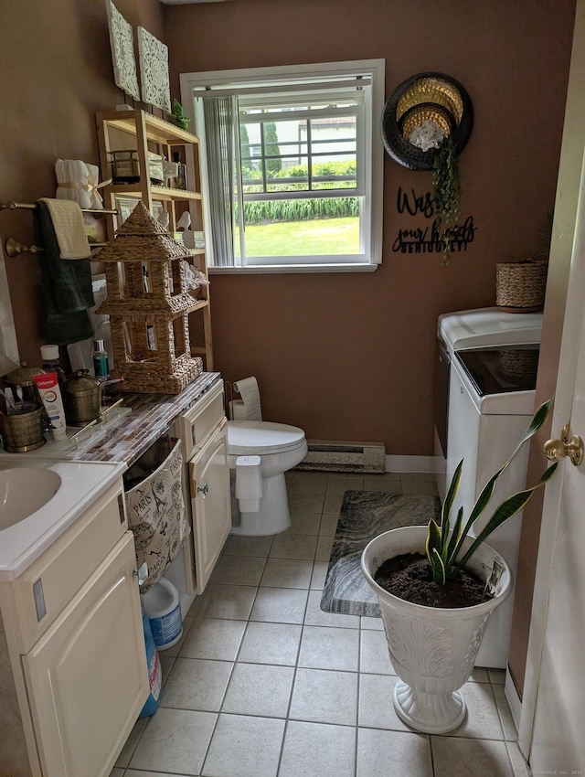 101 Chipper Rd, Waterbury, CT 06704 - bathroom with baseboard heating, vanity, toilet, tile patterned floors, and washing machine and dryer